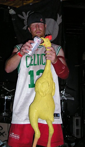 The drummer from Dr. Frog feeding beer to a rubber chicken